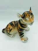 A small porcelain tiger made in Russia 13cm tall.