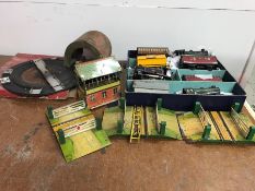 A large selection of Hornby,by Meccano, tin plate railway, buildings and trains.