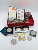 A selection of coins of various denominations including commemorative crowns and two pound coins