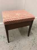 A Mahogany piano stool with string inlay and Zig Zag fabric seat.