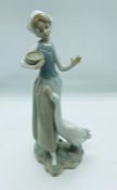 Lladro figurine of a women holding a small bowl feeding a goose