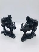 A pair of late 19th Century Asian carvings with silver work inlay.