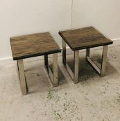 A pair of Grayson Industrial reclaimed solid wood side tables with glass tops and chrome legs.