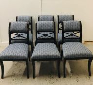 A set of six contemporary blue fabric upholstered dining chairs with brass stud detailing to back,