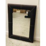 A Contemporary Leather padded mirror.