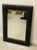 A Contemporary Leather padded mirror.