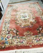 A Large Chinese rug with floral theme and tassled edge 246cm x 342cm