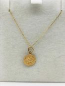 A 9ct gold chain and St.Christopher