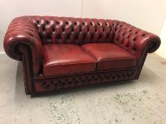 A Chesterfield style Ox Blood two seater sofa