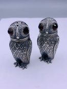 A pair of condiments in the form of owls with glass eyes stamped 800