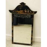 An Oriental black lacquered mirror.