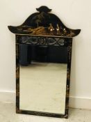 An Oriental black lacquered mirror.