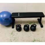 A Bulldog Gear bench and kettle drum set, along with an exercise ball.