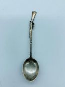 A Hallmarked silver teaspoon with a rifle handle