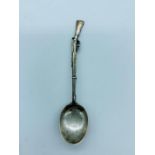 A Hallmarked silver teaspoon with a rifle handle