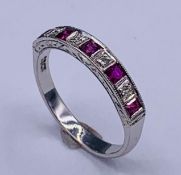 An 18ct white gold ruby and diamond chanel set ring