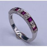 An 18ct white gold ruby and diamond chanel set ring