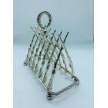 A silver plated toast rack in the form of rifles
