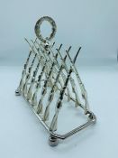 A silver plated toast rack in the form of rifles