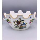 A Meissen Bowl with hand painted bird design and applied flowers.