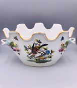 A Meissen Bowl with hand painted bird design and applied flowers.