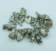 A silver Charm bracelet, including a rare Beatles charm.