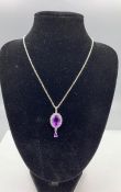 A silver CZ and amethyst drop pendant necklace on silver chain