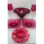 A selection of cranberry glass to include 4 square gold rimmed plater, 2 goblets, a large fruit bowl