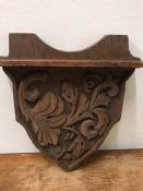 A Carved oak plaque of shelf.