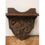 A Carved oak plaque of shelf.