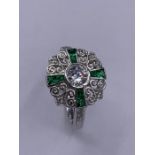A silver art deco style ring set with emeralds and CZ's