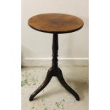 An Antique oak table on tripod legs.