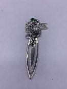 A silver bookmark with fairy finial set with emerald cabochon in the art nouveau style