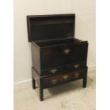 An Oak coffer on a raised base with drawer under