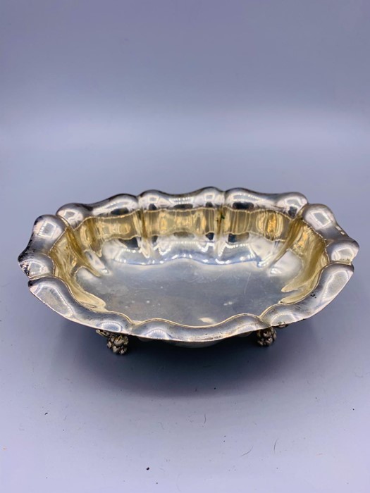 A Silver bowl on claw feet, marked 800