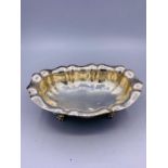 A Silver bowl on claw feet, marked 800