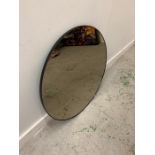 Circular mirror with thin black metal frame.