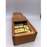 An Antique Domino set in a wooden box.
