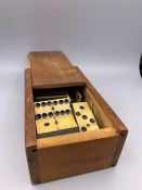 An Antique Domino set in a wooden box.
