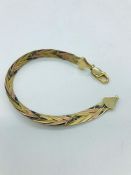 A 9ct three coloured gold bracelet
