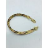 A 9ct three coloured gold bracelet