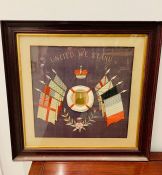 A Framed World War One 'United We Stand' silk with a central photo of a young man.