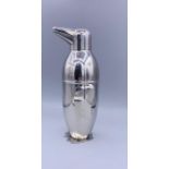 An unusual silver plated cocktail shaker in the form of a penguin