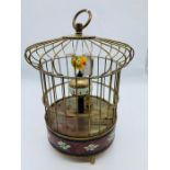 A brass cased singing bird clock