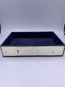 A Blue tray with silver panel sides.