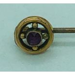 A 9ct gold and ruby lapel pin
