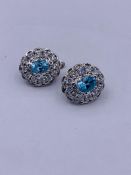 A pair of silver CZ and blue topaz cluster earrings