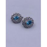 A pair of silver CZ and blue topaz cluster earrings