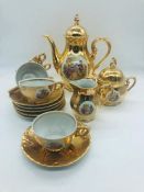A Tea set in gold with 18th Century scenes, six tea cups and saucers with matching Tea Pot, lidded