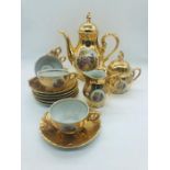 A Tea set in gold with 18th Century scenes, six tea cups and saucers with matching Tea Pot, lidded